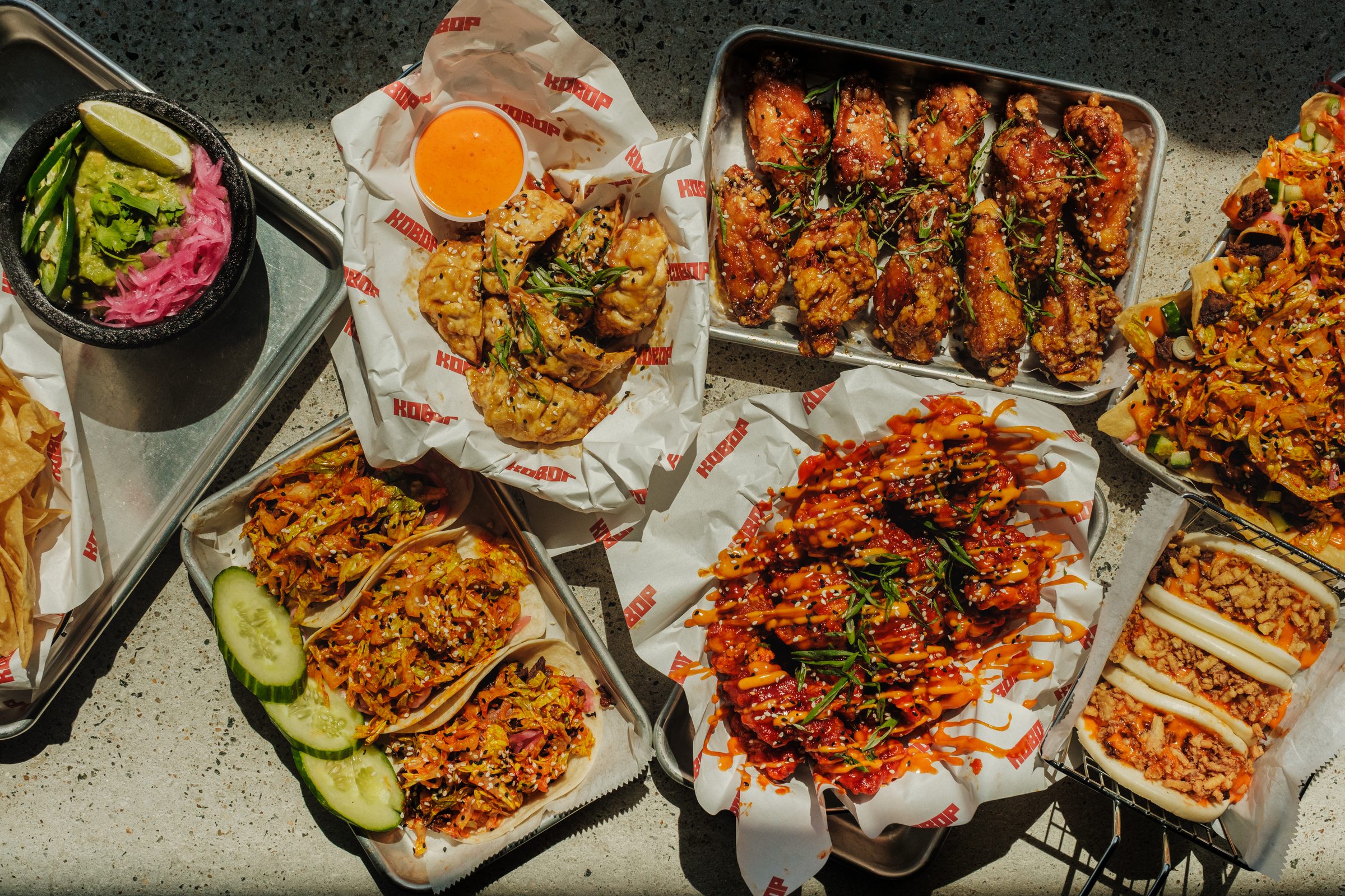 Kobop spread — wings, tacos, dumplings, chips & guac